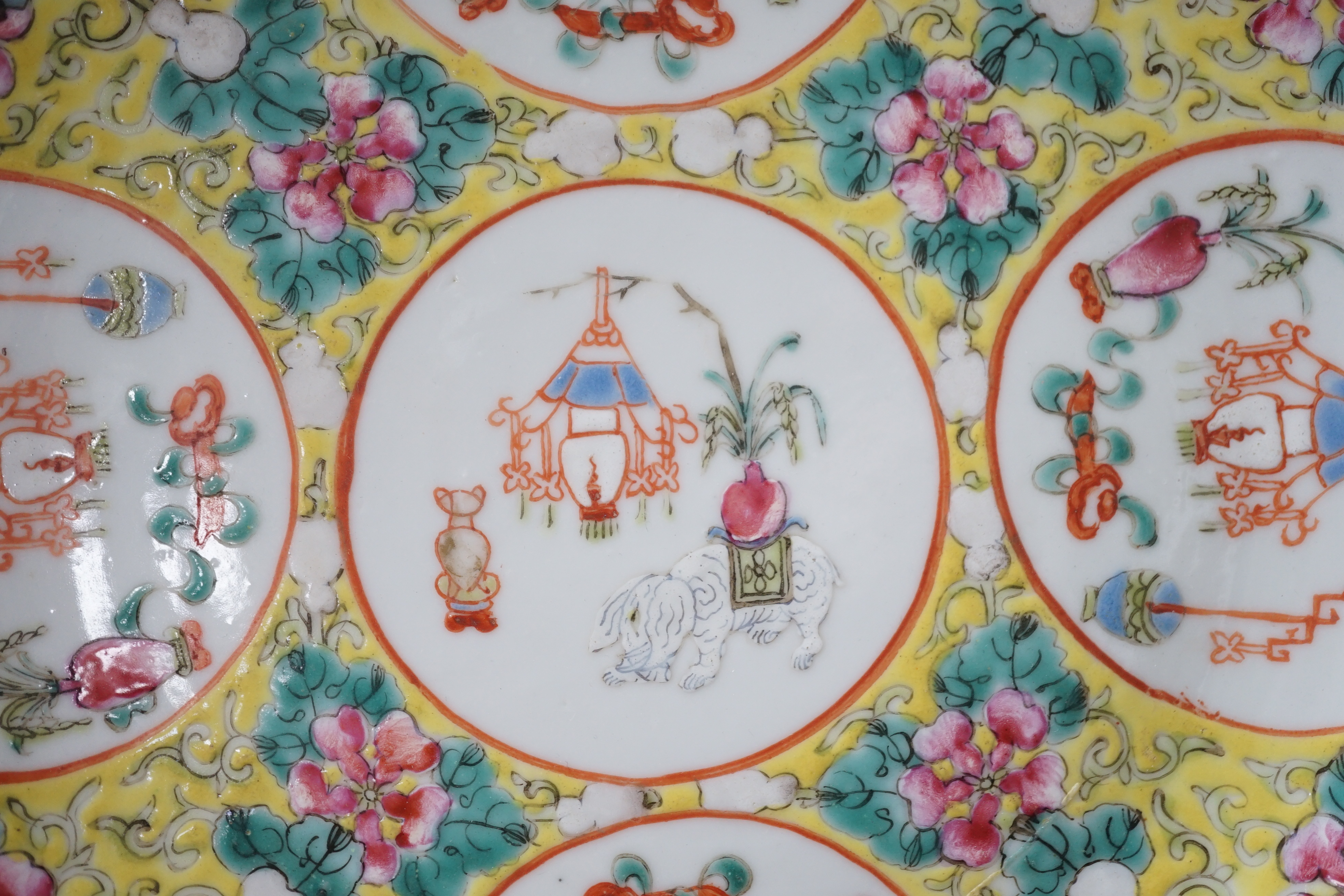A pair of Chinese yellow ground medallion saucer dishes, Guangxu six character marks, early 20th century, hairline crack to one dish